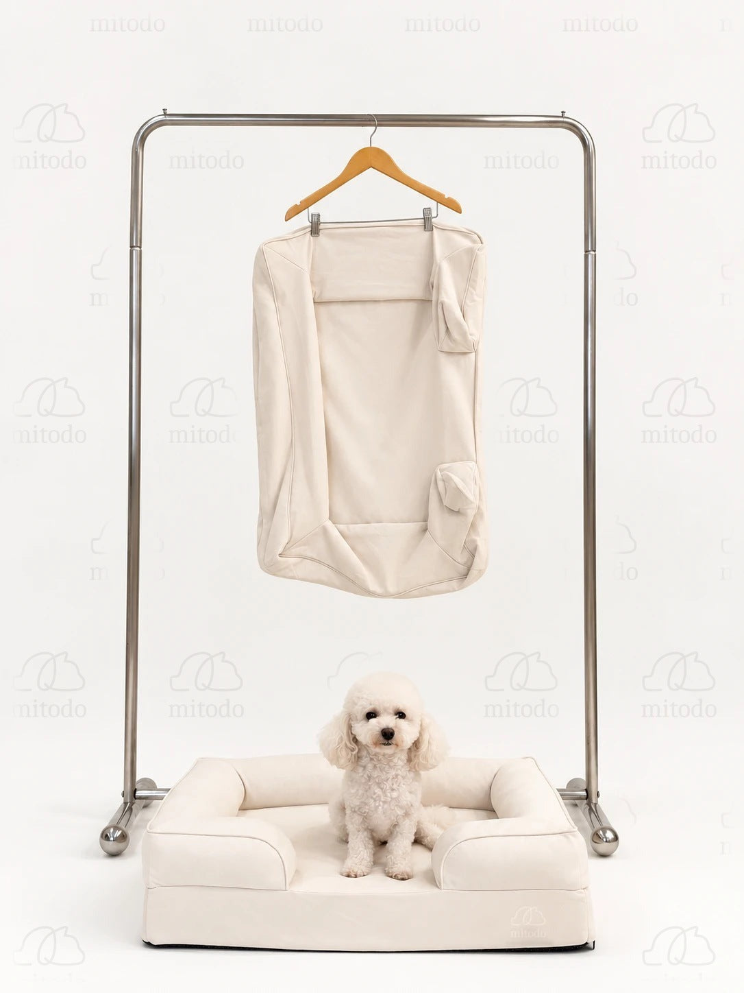 Kumo Bed + Spare Cover Set: a Kumo bed with a matching spare cover hanging on a rail above, and a white poodle sitting in the bed
