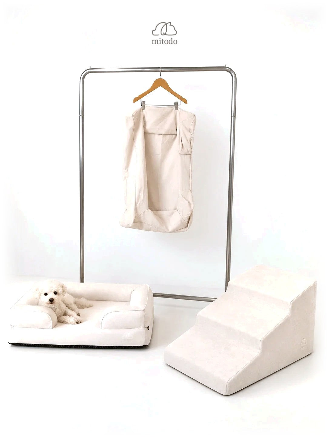 The Mitodo Complete Set in Cream: Mitodo Kumo bed with a dog, Sora stairs, and the spare cover on a hanger