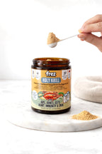 Frez Holy Krill supplement jar with a scoop of krill powder