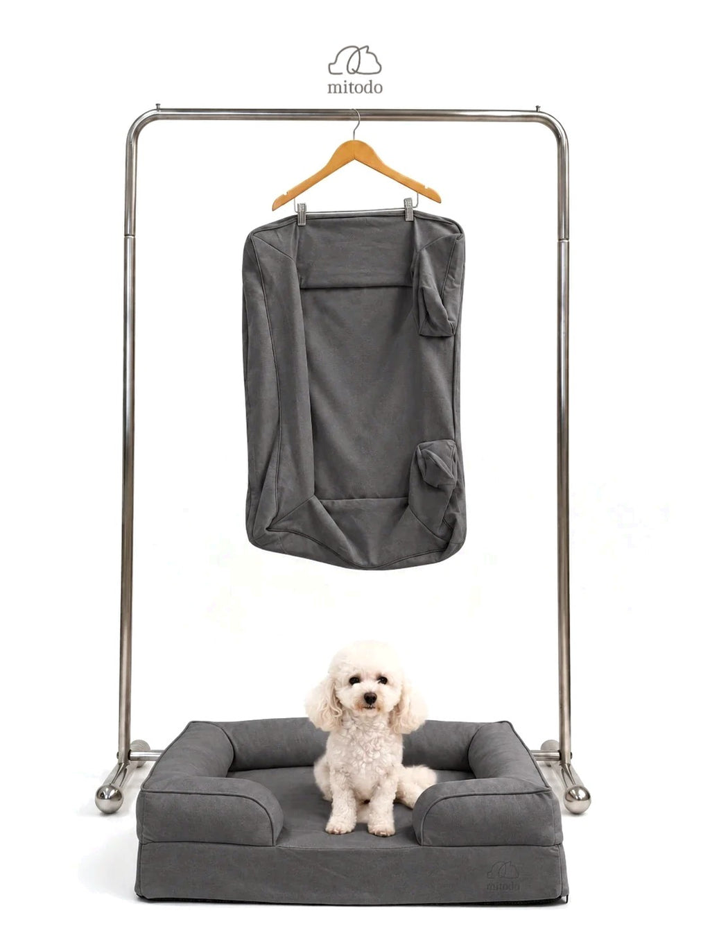 Mitodo Kumo Bed + Spare Cover Set: a Kumo bed with a matching spare cover hanging on a rail above, and a white poodle sitting in the bed