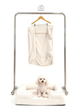 Mitodo Kumo Bed + Spare Cover Set: a Kumo bed with a matching spare cover hanging on a rail above, and a white poodle sitting in the bed