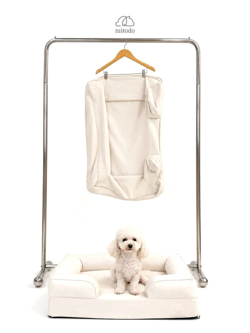 Mitodo Kumo Bed + Spare Cover Set: a Kumo bed with a matching spare cover hanging on a rail above, and a white poodle sitting in the bed